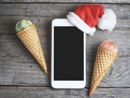 Smart phone and christmas hat with waffle ice creamの写真素材