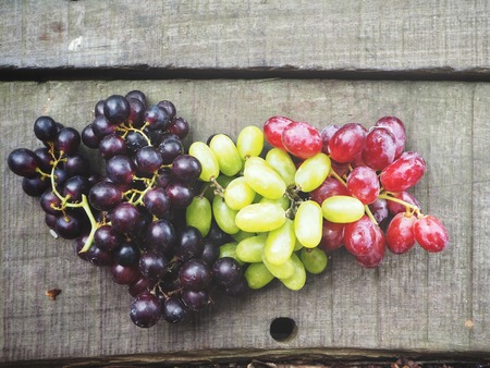 Red and white grapes with wine grapes.の写真素材