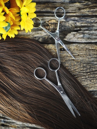Hair cutting shears and hair with flowersの写真素材