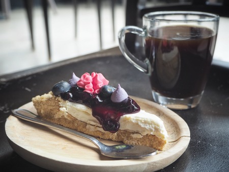 Blueberry tart and black coffee cupの写真素材