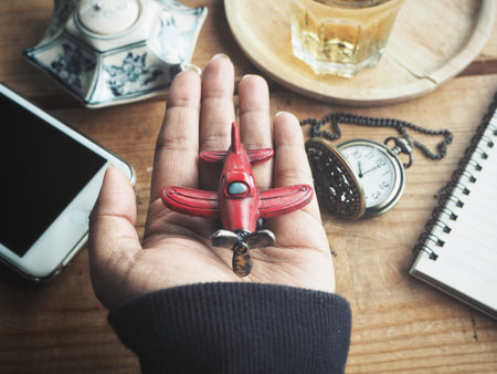 Accessories of airplane toy on hand travel concept