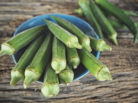 Green okra on wood backgroundの写真素材