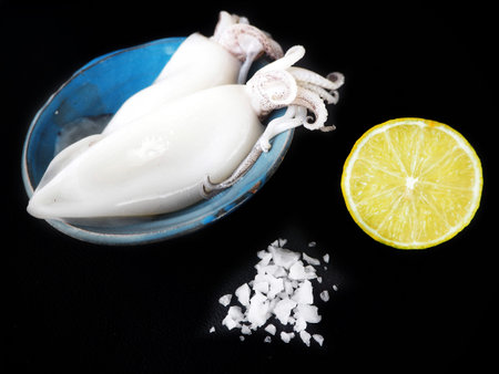 Fresh squid seafood on black backgroundの写真素材