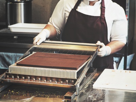 Chef making chocolate in the kitchenの写真素材