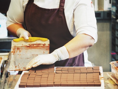Chef making chocolate in the kitchenの写真素材