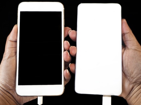 Power bank charger and smart phone on black backgroundの写真素材