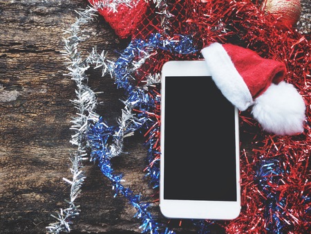 Smart phone with christmas hatの写真素材