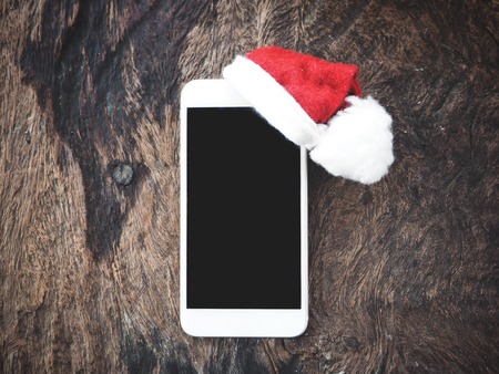 Smart phone with christmas hatの写真素材