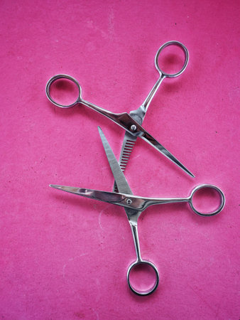 Hair cutting shears on pink background