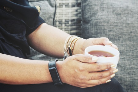 Hot coffee on handsの写真素材