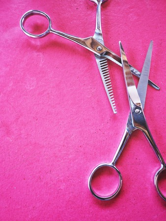 Hair cutting shears on pink backgroundの写真素材