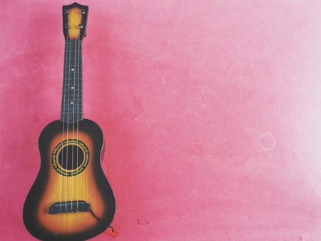 Guitars ukulele on pink backgroundの写真素材