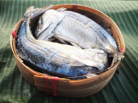 Steamed fish on banana leaves backgroundの写真素材
