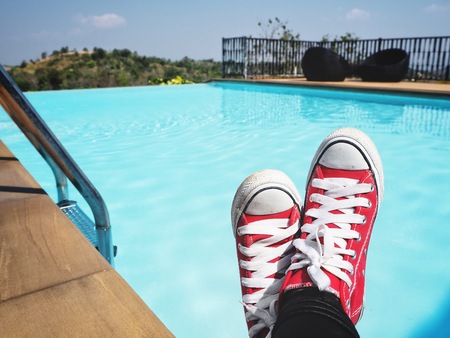Selfie of red sneakers with swimming pool slifestyle so coolの写真素材