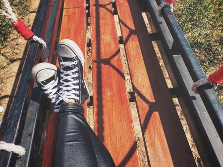 Selfie of black sneakers on suspension bridge lifestyle so coolの写真素材