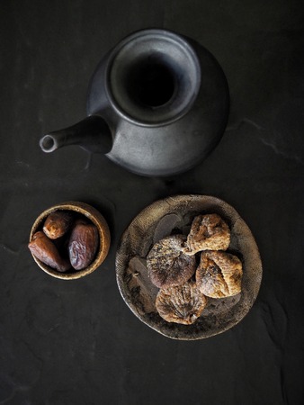 Fig and date fruits on black backgroundの写真素材