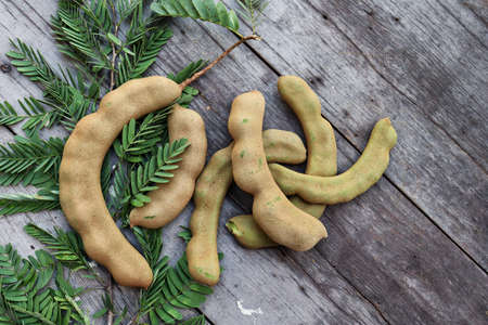 Tamarind and leaves on wood backgroundの写真素材