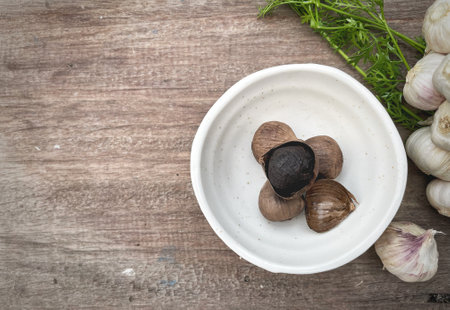 Black garlic on wood backgroundの写真素材