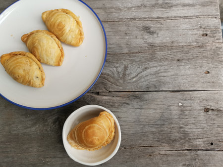 Curry puff on wood backgroundの写真素材