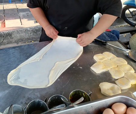 Woman cooking Indian naan bread street food