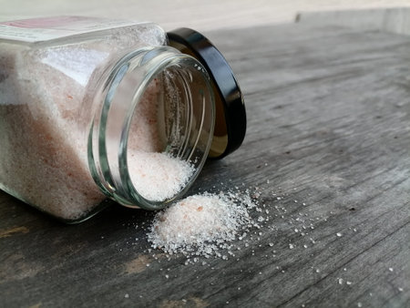 Himalayan pink salt on table wood background