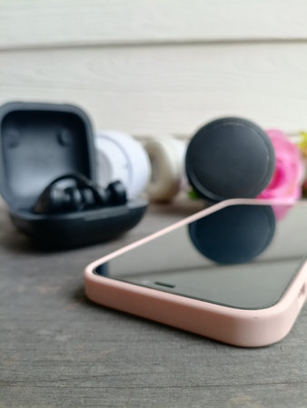 Headphones and black bluetooth speaker on table wood backgroundの写真素材