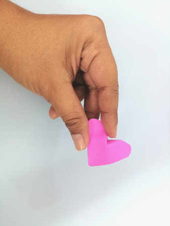 Pink paper hearts and hand