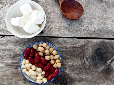 Red beans and white beans chickpeas cheese on wood background