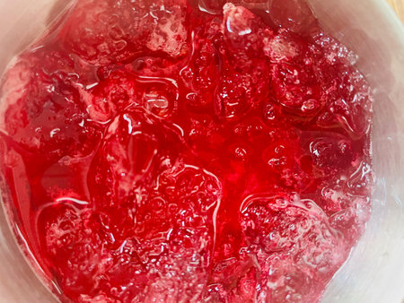 Red soft drink and ice cubes
