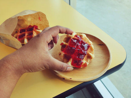 Breakfast of waffle with strawberry jamの写真素材