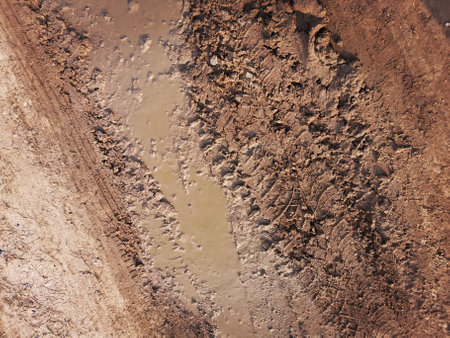 Wheel tracks on the soil road background or textureの写真素材