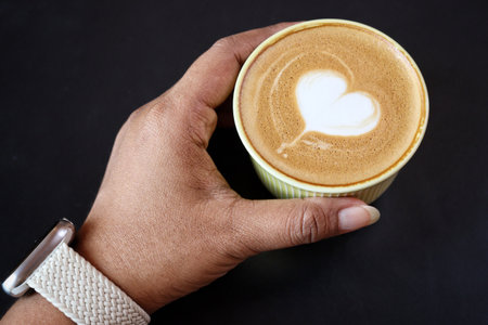 Heart of latte art coffee on handの写真素材