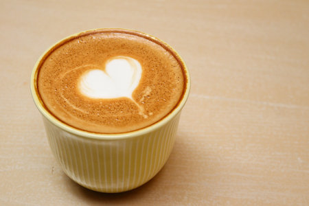 Heart of latte art coffee on wood backgroundの写真素材
