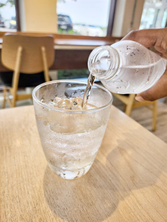 Pouring drinking water in a glassの写真素材