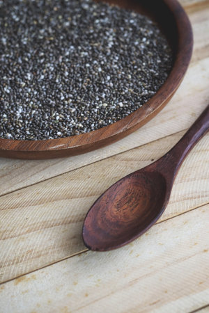 Chia seeds on brown wood backgroundの写真素材