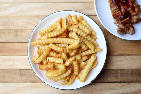 French fries on wood background