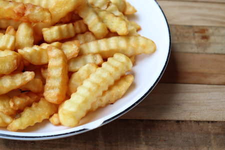 French fries on wood background