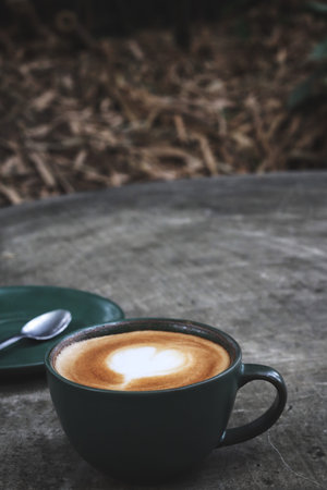 Latte art coffee cup on wooden table