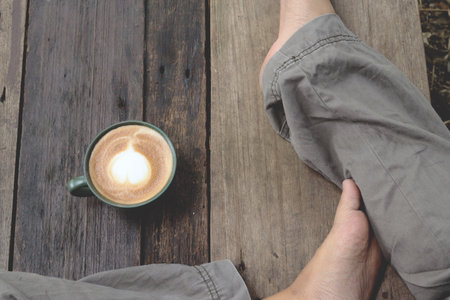 Selfie of coffee heart latte art milk foam on cupの写真素材