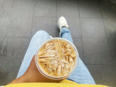 Selfie of iced coffee with milk latte  on handの写真素材
