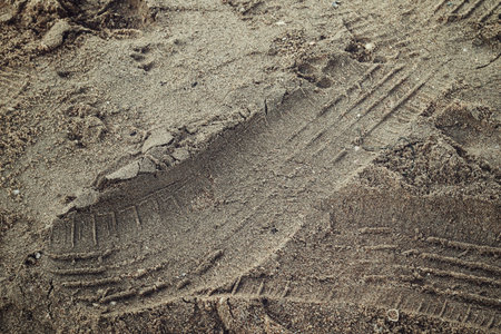 Wheel tracks on the soil road background or textur