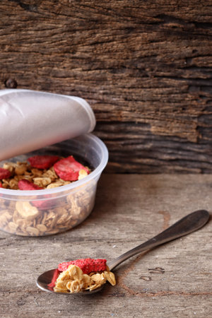 Granola and strawberry dried fruits on boxの写真素材