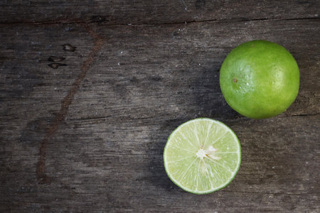 Green lime on wood backgroundの写真素材