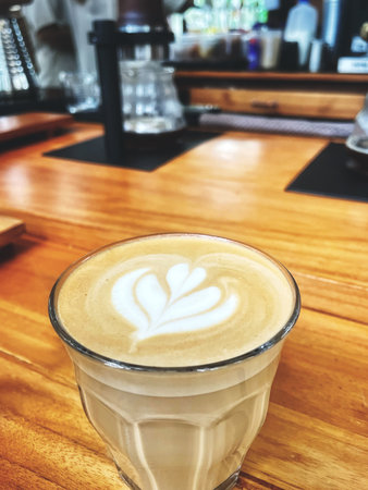 Latte art on brown wooden tableの写真素材