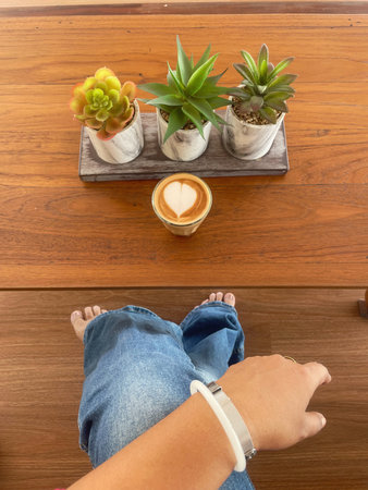 Selfie of women drinking coffee latte art milk foam on handの写真素材