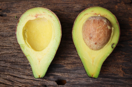 Fresh avocado halves on wooden backgroundの写真素材