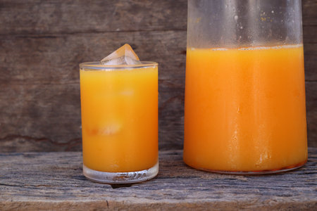 Soft drinks orange juice and iced in glassの写真素材