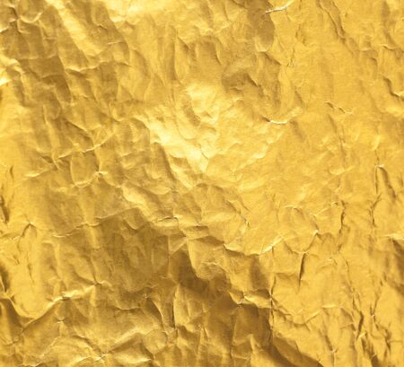 Shiny yellow gold foil abstract texture backgroundの写真素材