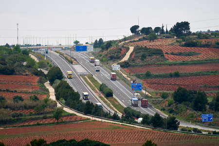 highway with several lanes where several trucks circulate in time of pandemicのeditorial素材
