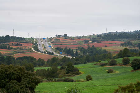 highway with several lanes where several trucks circulate in time of pandemicのeditorial素材
